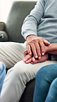 Senior, couple and holding hands with nurse for consultation, diagnosis or healthcare advice at home. Closeup, elderly people or listening with caregiver or empathy for medical care or breaking news