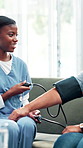 Woman, nurse and elderly care with blood pressure machine for cardiac arrest, exam or checkup at home. Female person, caregiver or healthcare volunteer with senior patient for monitoring heart rate