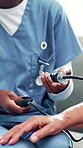 Nurse, hands and elderly care with blood pressure machine for cardiac arrest, exam or checkup at home. Closeup, caregiver or healthcare volunteer with arm strap on patient for monitoring heart rate