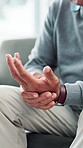 Home, hands and senior man with wrist pain, inflammation and osteoporosis in lounge. Pensioner, closeup and mature person with arthritis, muscle tension and joint injury with ache and carpal tunnel