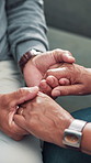 Holding hands, old couple and support with love, empathy and retirement with relationship. Closeup, home and man with woman, apartment and kindness with marriage, trust and comfort in living room
