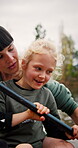 Mother, kid and learning to kayak in lake for travel adventure, recreation and holiday activity. Talking, woman and girl in boat for family bonding, rowing and teaching to paddle on weekend vacation