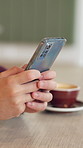 Person, hands and phone in coffee shop for social media, typing message and hospitality at table. Customer, mobile and connectivity in restaurant for online blog, service review and research in app