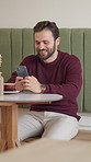 Relax, laughing or happy man in cafe with phone for online review, text message and social media chat. Restaurant menu, smile and customer in coffee shop with mobile for break, funny joke or meme