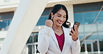 Business, woman and celebration with phone in city for achievement, promotion email and corporate milestone. Professional, employee and victory fist with dancing for job opportunity, success or bonus