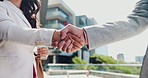Outdoor, handshake and business people with partnership, closeup and b2b deal with recruitment. Employees, human resources and candidate with greeting, shaking hands and welcome with agreement