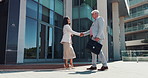 Outdoor, handshake and business people with greeting, agreement and b2b deal with recruitment. Employees, human resources and candidate with onboarding, shaking hands and welcome in New York