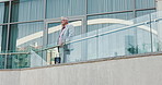 Thinking, balcony and business man in city with confidence, pride and future ideas for company. Professional, corporate and person by office building outdoor for planning, inspiration and opportunity