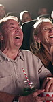 Happy, laughing and senior couple in cinema for movie on date together for anniversary celebration. Love, entertainment and elderly woman with man cuddle for watching film at theater with snacks.