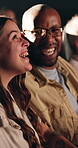 Laugh, movie and happy couple in cinema audience for premiere and entertainment. Theatre, interracial people and comedy or joke of show, performance and watching film with partner, spectator and fun