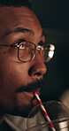 Drink, movie and man in cinema audience for premiere and entertainment. Theatre, person drinking and suspense or horror of show, performance and watching film with glasses, spectator and straw