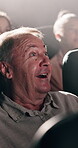 Senior, happy man and surprise with movie at cinema for suspense, shock or entertainment. Elderly, male person or watching with smile, wow or fright for performance or motion picture in dark theater