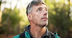 Thinking, mature man and hiking in forest for trekking adventure, travel reflection and holiday. Male person, planning and backpacking in woods for hobby, sightseeing and explore journey with getaway