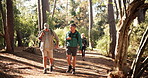 Hiking, people and men in woods, walking and bonding together with conversation, wellness and journey. Outdoors, traveller and hikers in forest, health or support with fitness, environment or talking
