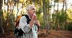 Thinking, senior man and walk in woods for hiking adventure, retirement hobby or cardio fitness. Mature person, relax and journey with backpack for trekking, explore or holiday sightseeing in forest