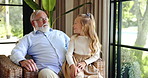 Happy, relax and grandfather with child in home with bonding, love and family time. Smile, conversation and senior man with girl kid for talking with knowledge together in living room in house.