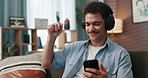 Headphones, dance and man with cellphone on sofa in home for chatting, relaxing and listening to music. Audio tech, phone and person with networking and streaming album on mobile app in living room.