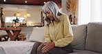 Senior woman, sofa and injury with knee pain for arthritis, joint inflammation or fibromyalgia at home. Elderly, female person or patient with sore leg, bone or nerve for osteoarthritis disease