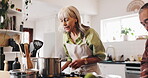 Cooking, help and pasta with old couple in kitchen for food recipe, nutrition and healthy diet. Meal prep, dinner planning and retirement with senior man and woman at home for love, bonding or hunger