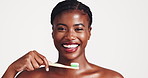 Dental health, face and black woman brushing teeth in studio for morning routine with hygiene. Oral care, portrait and African female person with toothbrush for fresh breath by white background.