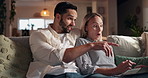 Laptop, pointing and smile with happy couple on sofa in living room of home together for evening bonding. App, computer or relax with man and woman in apartment at night for internet browsing