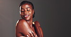 Space, skincare and black woman in studio for beauty, cosmetics and treatment for grooming. Dermatology mockup, spa aesthetic and person with touch for wellness, salon and glow on gray background