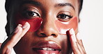Black woman, face or studio with eye mask for skincare, collagen or cosmetics on a white background. Portrait, female person or model with gel patches for skin vitamin, anti aging or facial hydration