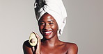 Happy, black woman and face with avocado for skincare nutrition or health on a white studio background. Portrait, female person or model with smile or natural vegetable for vitamins on mockup space