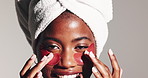 Black woman, face and skincare with eye patches in studio for facial collagen on a white background. Portrait, female person or model with smile or gel mask for skin hydration, vitamin or dermatology