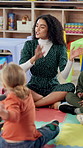 Education, teacher and singing with children in classroom for nursery rhyme, language development and learning. Kindergarten, people and happy with creative activity for motor skills and daycare fun