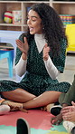 Singing, classroom and teacher with children on floor for music lesson, education and learning. School, happy students and kids with educator for creative activity, language development and knowledge