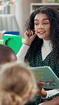 Woman, teacher and reading book with children for learning, education or listening lesson at school. Female person, educator or kids with story or kindergarten novel for hearing skills in classroom