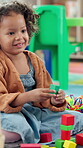 Kindergarten, child and happy with blocks for education, creative and cognitive development in class. School, students and girl with building toys for learning, motor growth and problem solving skill