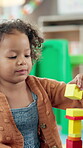Classroom, child and happy with blocks for education, creative and cognitive development in school. Kindergarten, student and girl with building toys for learning, motor growth and shock reaction