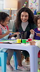 Teacher, paint and children in classroom for art lesson, talking or smile with color, craft and creativity. Drawing, watercolor and woman with students for artwork, paintbrush and preschool activity