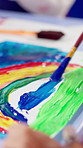 Painting, brush and hands of child in classroom at preschool for activity, hobby or cognitive development. Fun, student and closeup of kid with art for creative, poster or sign at elementary academy.