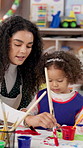 Teacher, paint brush and kids in classroom for art lesson, help or show with color, craft and creativity. Drawing, watercolor and woman with students for artwork, learning and preschool activity