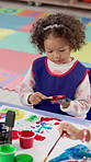 Children, hand and girl painting for art at school with learning, creativity and handprint picture. Education, messy or kid with activity for development with paintbrush for kindergarten artwork