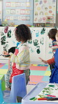 Painting, education and kids in classroom at preschool for creativity, hobby or activity. Learning, students and group of children with canvas for colorful art with development, skills or growth.