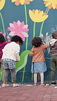 Chalk, drawing and children at preschool for creativity, growth or skill development at mural wall. Education, students and kids outdoor with art for activity, hobby or lesson at kindergarten.