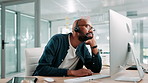 Call center, thinking and black man in office bored for customer service, online help and CRM support. Professional, consultant and tired worker on computer for feedback, contact us and advice