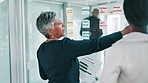 Business people, glass wall and brainstorming in office, planning or meeting for problem solving. Employees, corporate report or thinking in workplace, discussion or sticky notes with ideas or choice