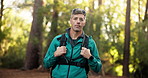 Face, mature man and hiking in forest for trekking adventure, travel and fitness holiday. Portrait, male person and backpacking in woods for hobby, sightseeing and explore journey for getaway trip