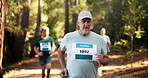 Runner, fitness and mature man in forest for exercise, marathon training and cardio workout. Group, nature and people in woods for wellness, healthy body and endurance with race or competition