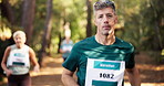 Man, running and forest with group for marathon challenge, race or endurance test in nature. Mature, male person or runner with people for sport event, jogging competition or outdoor fitness in woods