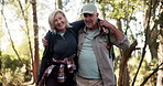 Senior, happy couple and walking adventure in forest with help for support, journey together or outdoor trip. Elderly man, woman or hiking with assistance or care for health safety, aid or trekking