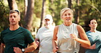 People, running and fitness in forest for exercise, cardio workout or marathon together in nature. Mature friends, group or runners jogging with smile for race challenge, health and wellness in woods