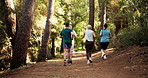 People, back or running in forest for marathon challenge, race or jogging together in nature. Team, runners or community with group, trail or path for sprint, fitness competition or outdoor exercise