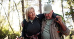 Senior couple, walking or adventure with help in forest for support, journey together or outdoor trip. Elderly man, woman or hiking with assistance or care for health safety or aid on trekking trail