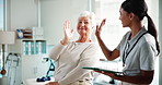 Happy woman, senior and high five with physiotherapist for winning, good news or thank you at clinic. Elderly, female person or client with healthcare worker or tablet for checkup success at hospital